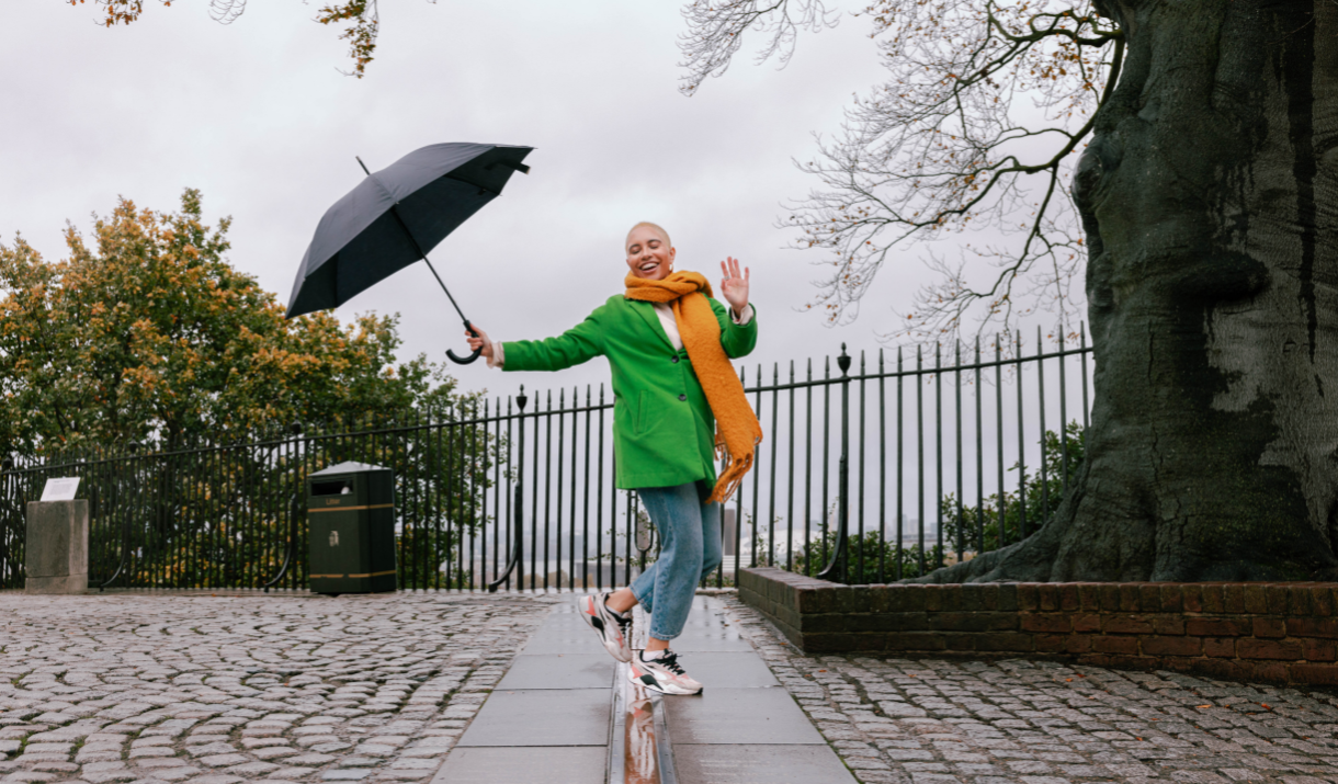 Woman on Meridian Line at Royal Observatory Greenwich with an umbrella